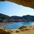 View of a beach through a cave