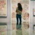 A visitor looking at the Minoan Wall Paintings at the Archeological Museum of Crete