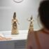 Visitor of the Archaeological museum looking at the Snake Goddess Figurine