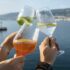Hands holding glasses with drinks close up